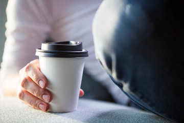 Young woman holding disposable coffee cup. Youth, modern lifestyle. Coffee break, cosy relaxing moment. 