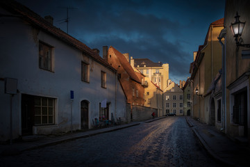 cobblestone streets in the old city of Tallinn in Estonia with centuries-old houses at sunset