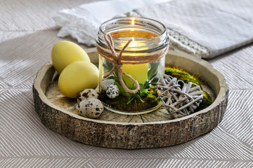 A candle holder made of an old glass. Homemade Easter table decoration.