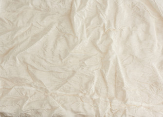 crumpled beige synthetic fabric for the manufacture of lining for skirts