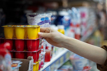 Supermarket showcase, shopping market products, woman shopping