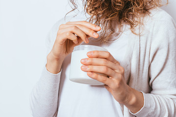 Woman's hands apply cosmetic moisturizing oil
