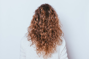 Rear view woman's head with beautiful long naturally curly hair - Powered by Adobe