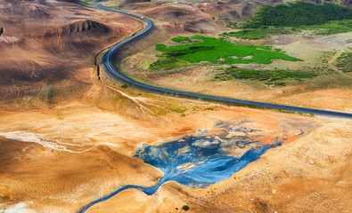 Aerial view on road in Iceland. Aerial landscape above highway in the geysers valley. Icelandic...