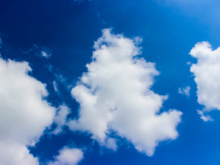 White clouds against a dark blue sky.