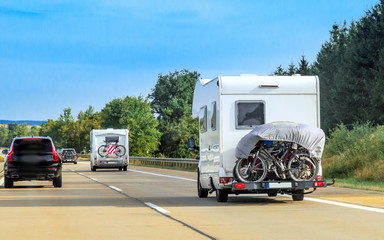 Caravans with bicycles on the road in Switzerland.