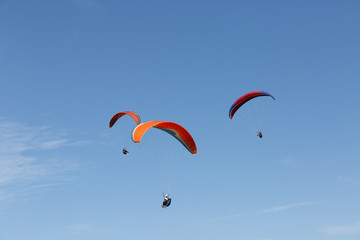 Three paragliders flying in a day of ideal conditions