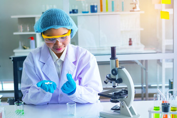 Body past scientist working in laboratory.Chemical scientist show white medicine.She...