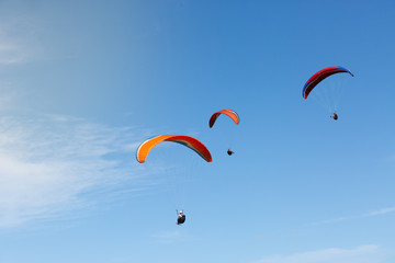 Three paragliders flying in a day of ideal conditions