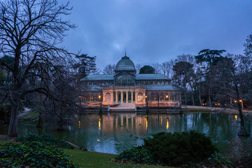 Obraz premium Front view of the Crystal Palace in El Retiro Park in Madrid at dawn, cloudy day, romantic style pavilion, travel concept