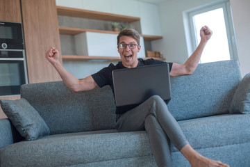 emotional man watching video on his laptop.