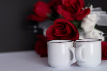 White mugs red white roses black background valentines