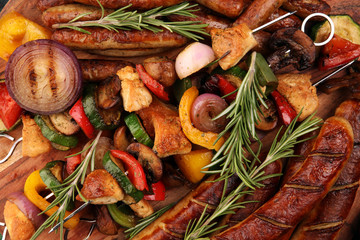 Assorted delicious grilled meat with vegetable on a barbecue with Grilled pork shish or kebab on skewers with vegetables.