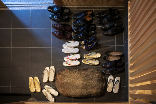 Leather Shoes And Traditional Japanese Sandals Arranged In Entryway