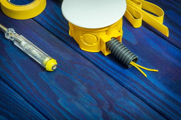 Electrical junction yellow box with wires and tool usually used in the electric installation process