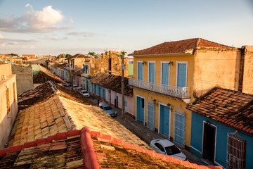 Fototapeta na wymiar Sunset view of Trinidad - colonial town in Cuba, taken from roof terrace with a view on street with colorfoul housing