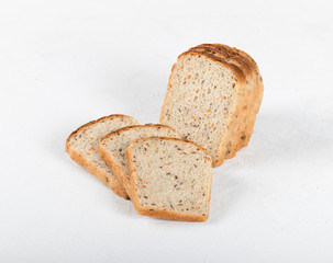 Whole grain fitness bread with dried carrots and flax, pumpkin, and sunflower seeds, sliced on a light background
