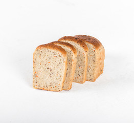 Whole grain fitness bread with dried carrots and flax, pumpkin, and sunflower seeds, sliced on a light background