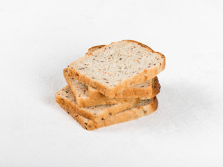 Whole grain fitness bread with dried carrots and flax, pumpkin, and sunflower seeds, sliced on a light background