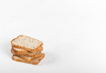 Whole grain fitness bread with dried carrots and flax, pumpkin, and sunflower seeds, sliced on a light background