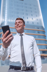 close up. happy business man with a smartphone