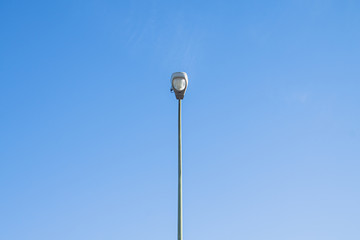 Streetlamp at day with blue sky in background