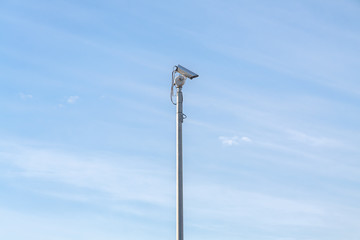 Security camera at day with blue sky in background