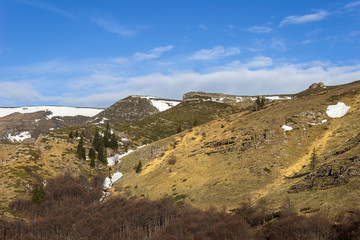 Amazing, rocky, alien highlands of juniper covered Old mountain and transition from winter to spring season