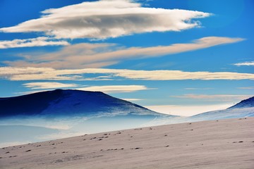 winter landscape with mountains and blue sky