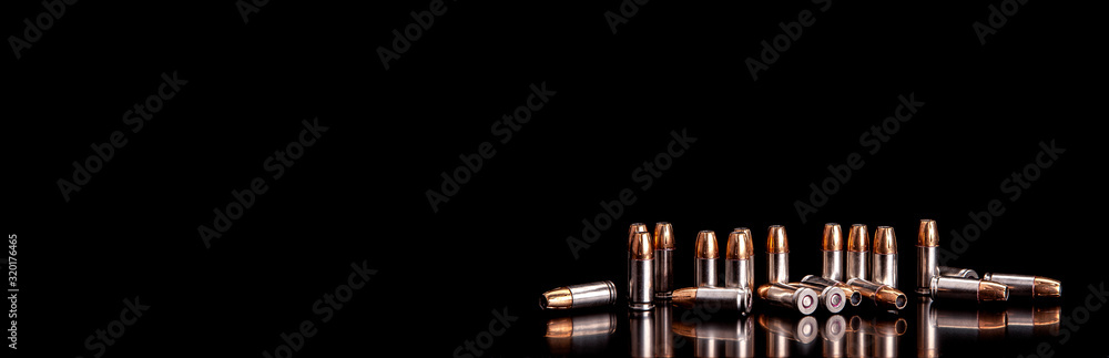 Wall mural Bullet isolated on black background with reflexion. Rifle bullets close-up on black back. Cartridges for rifle and carbine on a black.