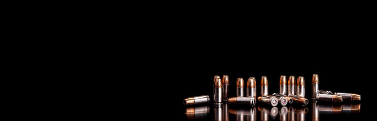 Bullet isolated on black background with reflexion. Rifle bullets close-up on black back....