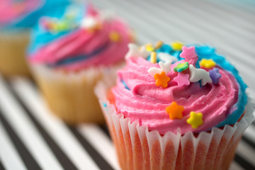 Cupcakes with blue and pink icing on a blue background