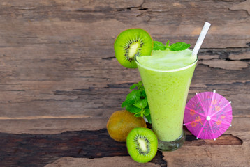 Kiwi yogurt fruit juice smoothie green colorful fruit juice milkshake blend beverage healthy high protein the taste yummy In glass drink episode morning on wood background.