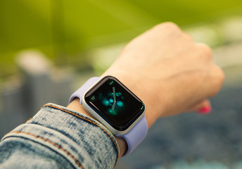 Young girl look at the time on her smart watch.