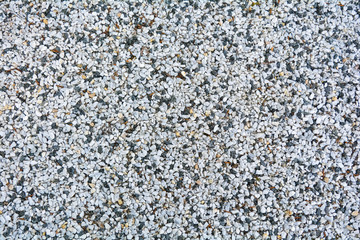 Small White, black, yellow pebble background. Top view of gravel stone texture