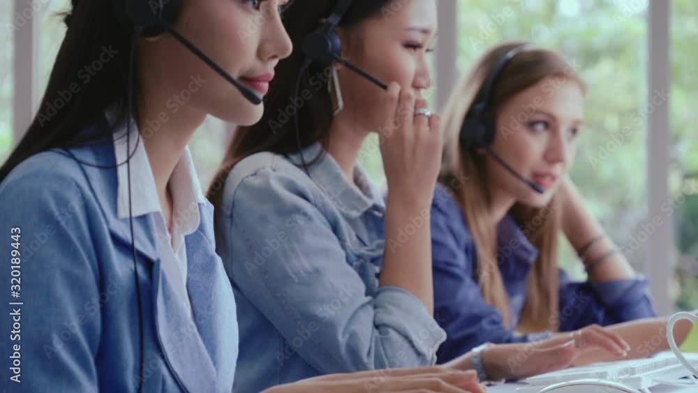 Aufkleber customer support agent or call center with headset works on desktop computer while supporting the cu