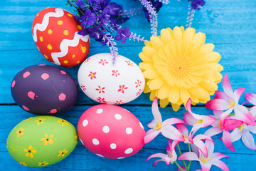 Easter eggs top view on blue wooden background