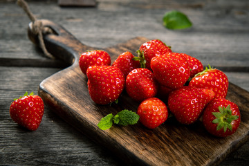 Fresh picked tasty strawberries on wooden background