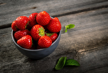 Fresh picked tasty strawberries on wooden background