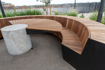 outside tables and benches on a rooftop lounge