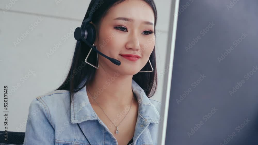Aufkleber customer support agent or call center with headset works on desktop computer while supporting the cu