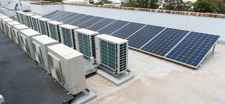 rooftop solar panels and air conditioning on top of an apartments in australia