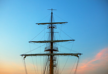 ship mast and ropes against evening sky