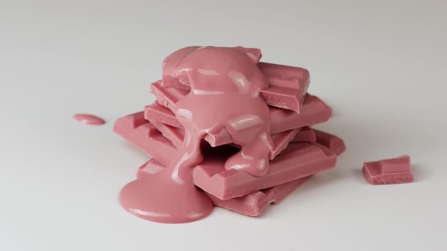 Melted ruby chocolate pouring into a piece of chocolate bars 