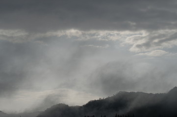 Naklejka na ściany i meble clouds over mountains