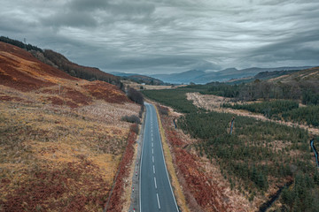 Fototapeta na wymiar Rainy Clouds over Empty Aphalt Road in Scottish Highlands