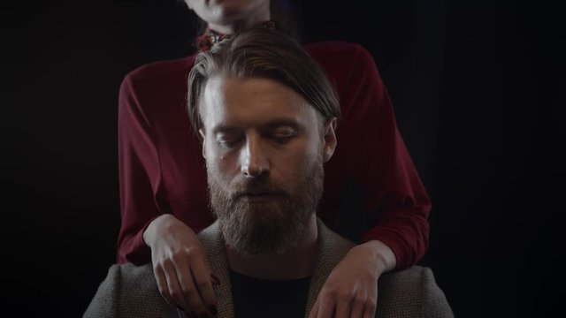 Bearded man smoking vape, woman touching beard of man with tender, slow motion