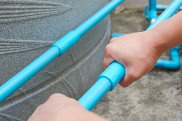 PVC pipe connecting. Hand with tube. Hand holding tube for joint connection.