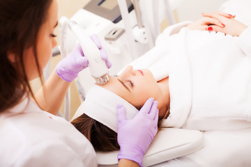 Woman getting LPG hardware massage at the beauty clinic