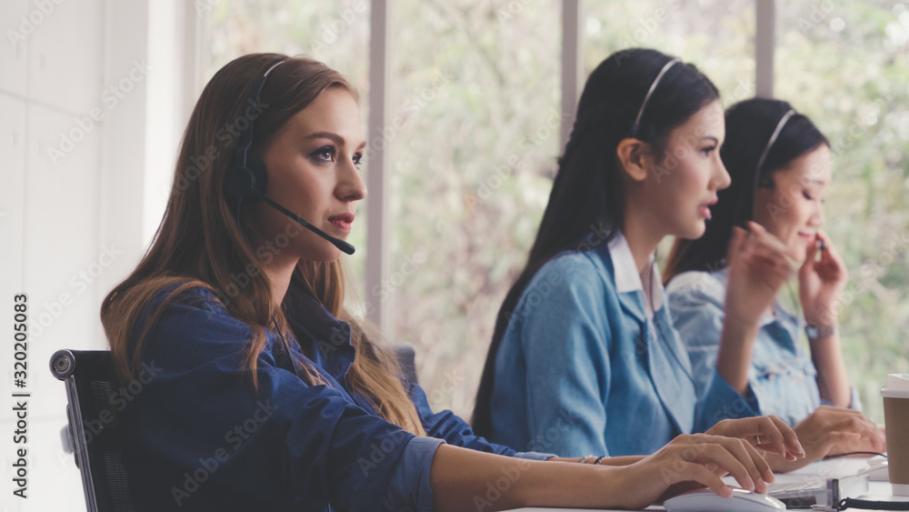 Aufkleber customer support agent or call center with headset works on desktop computer while supporting the cu